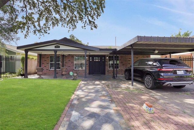 ranch-style house with fence, a carport, a front lawn, and brick siding