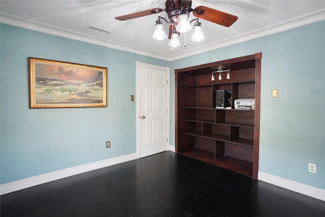 unfurnished room with crown molding, a ceiling fan, baseboards, and visible vents
