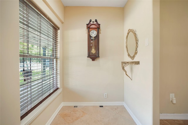 interior space featuring baseboards and a healthy amount of sunlight