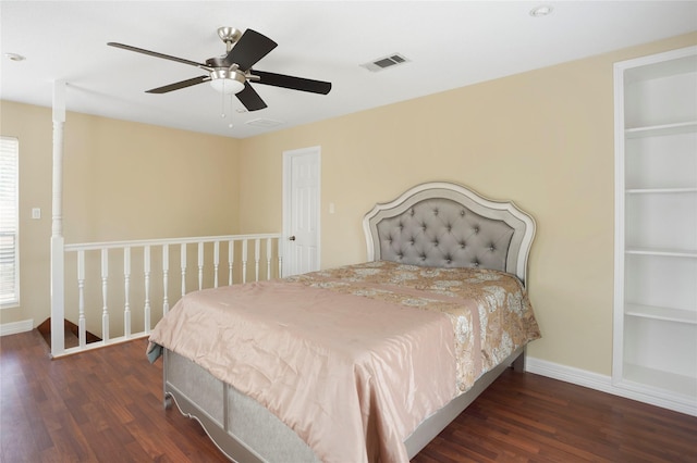 bedroom featuring baseboards, wood finished floors, and visible vents
