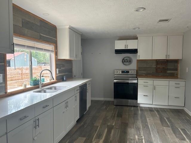 19101 Oak Canyon Dr, Conroe, TX 77385 - kitchen featuring visible vents, black dishwasher, under cabinet range hood, a sink, and stainless steel range with electric cooktop