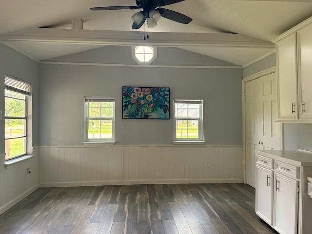 19101 Oak Canyon Dr, Conroe, TX 77385 - unfurnished dining area featuring vaulted ceiling with beams, dark wood-style floors, and a healthy amount of sunlight