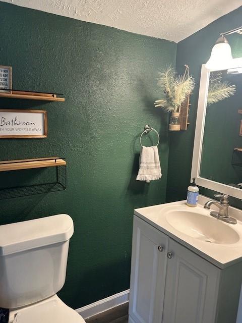 19101 Oak Canyon Dr, Conroe, TX 77385 - bathroom with vanity, a textured ceiling, a textured wall, and toilet