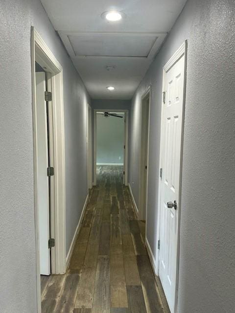 19101 Oak Canyon Dr, Conroe, TX 77385 - hall featuring baseboards, a textured wall, attic access, and dark wood-style flooring