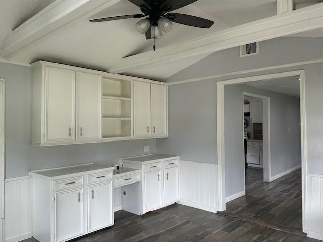 19101 Oak Canyon Dr, Conroe, TX 77385 - kitchen featuring ceiling fan, dark wood finished floors, white cabinetry, vaulted ceiling with beams, and visible vents