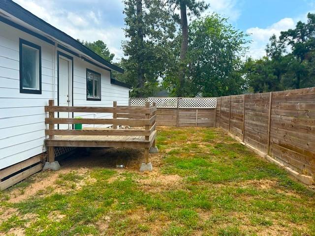 19101 Oak Canyon Dr, Conroe, TX 77385 - view of yard with a fenced backyard and a wooden deck