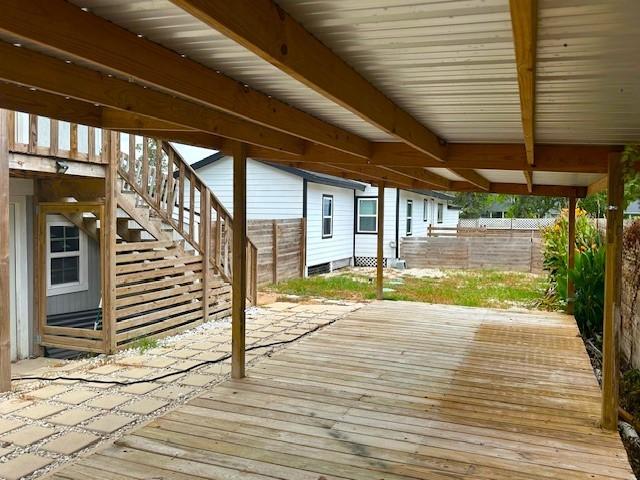 19101 Oak Canyon Dr, Conroe, TX 77385 - deck featuring a fenced backyard and stairs