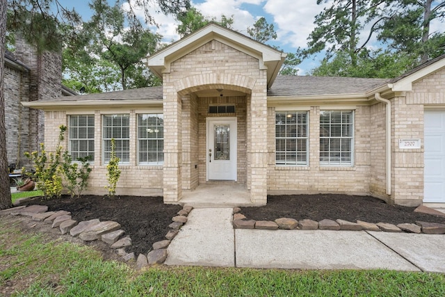 2707 Shawna Lyn Dr, Spring, TX 77373 - property entrance featuring brick siding and roof with shingles