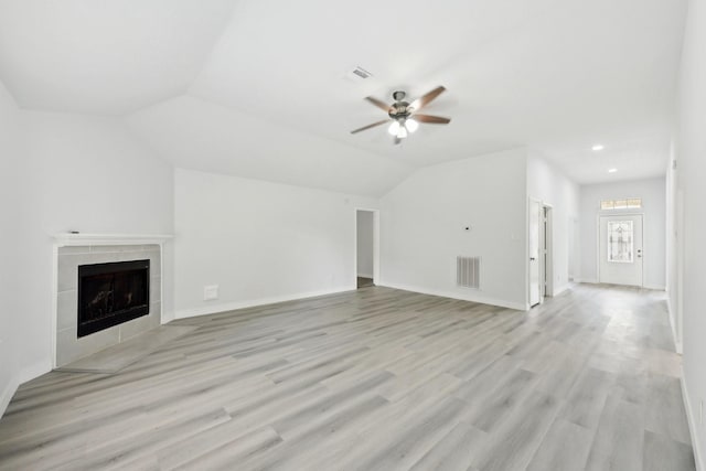 2707 Shawna Lyn Dr, Spring, TX 77373 - unfurnished living room featuring light wood-style flooring, a ceiling fan, a tile fireplace, and lofted ceiling
