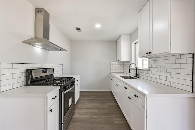 kitchen with stainless steel gas range, wall chimney range hood, a sink, tasteful backsplash, and visible vents