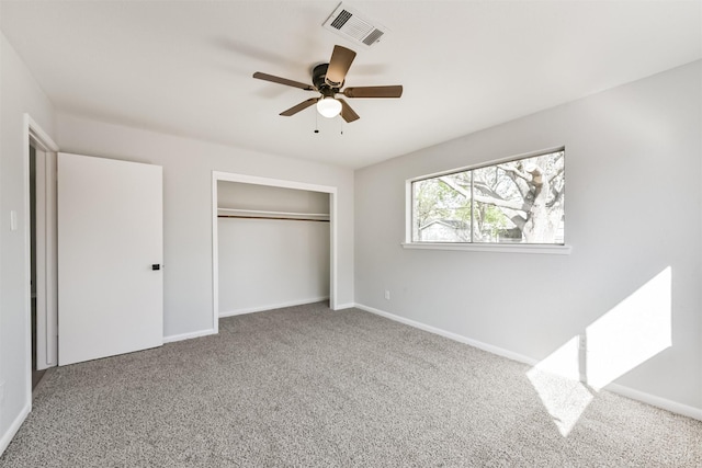 unfurnished bedroom with a ceiling fan, visible vents, carpet floors, baseboards, and a closet