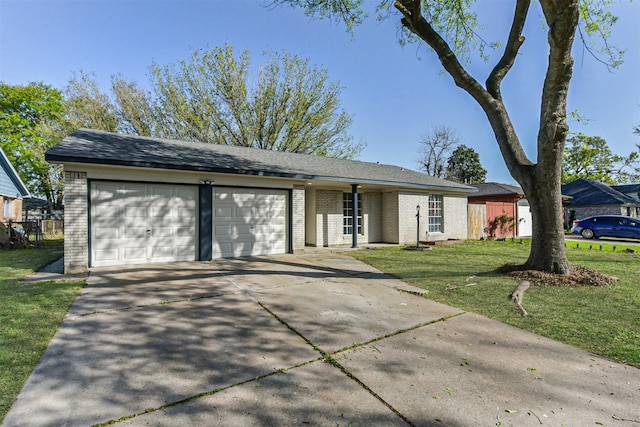 view of front of property with brick siding, a garage, a front lawn, and driveway