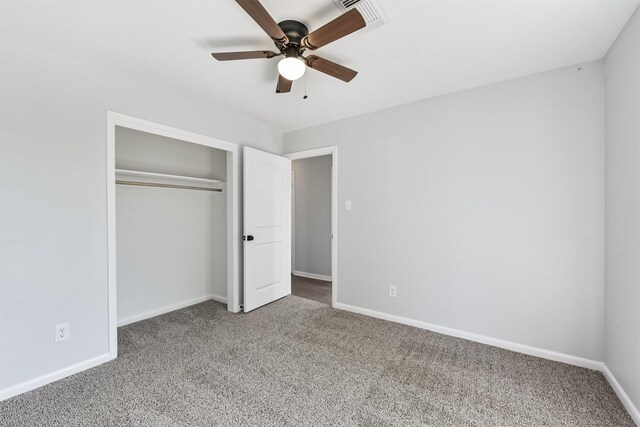 unfurnished bedroom with carpet floors, baseboards, visible vents, and a closet