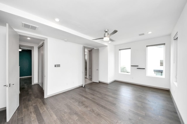 interior space with a ceiling fan, baseboards, visible vents, and wood finished floors