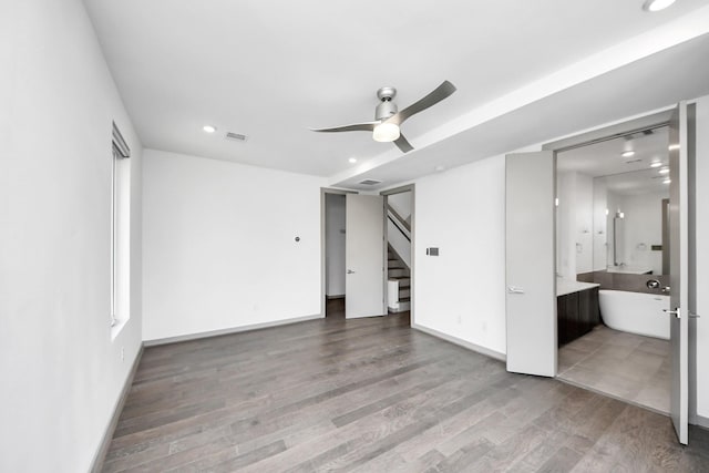 unfurnished bedroom with connected bathroom, recessed lighting, baseboards, wood finished floors, and visible vents