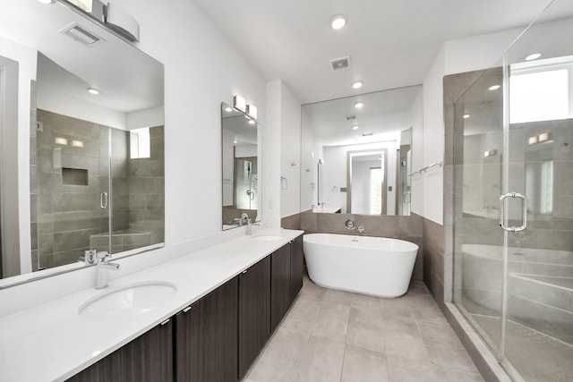 full bath featuring a sink, a shower stall, and visible vents