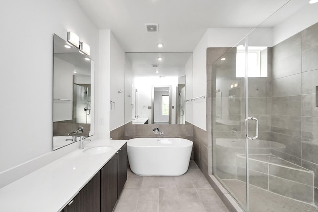 full bath with vanity, a freestanding tub, recessed lighting, tile patterned floors, and a stall shower