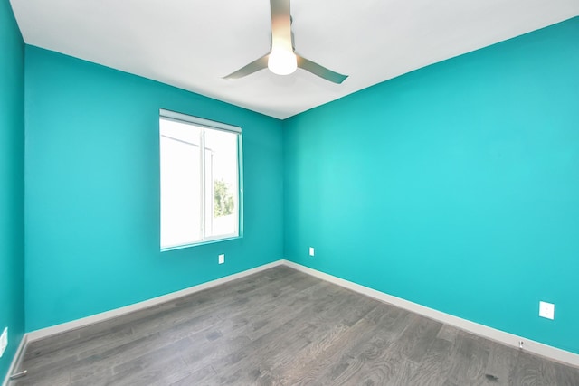 empty room featuring baseboards, ceiling fan, and wood finished floors