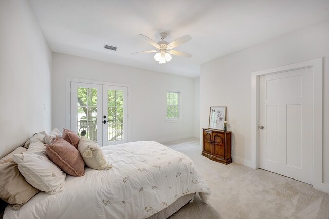 bedroom with ceiling fan, light carpet, access to exterior, baseboards, and visible vents
