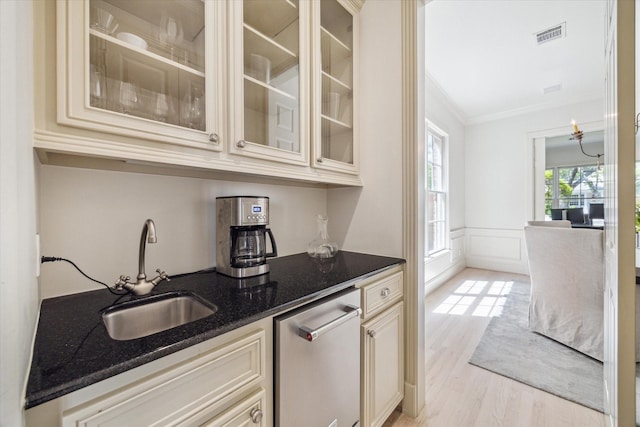 bar with stainless steel dishwasher, visible vents, ornamental molding, light wood-style floors, and a sink