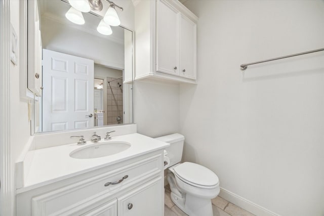 bathroom with vanity, baseboards, tile patterned flooring, and toilet