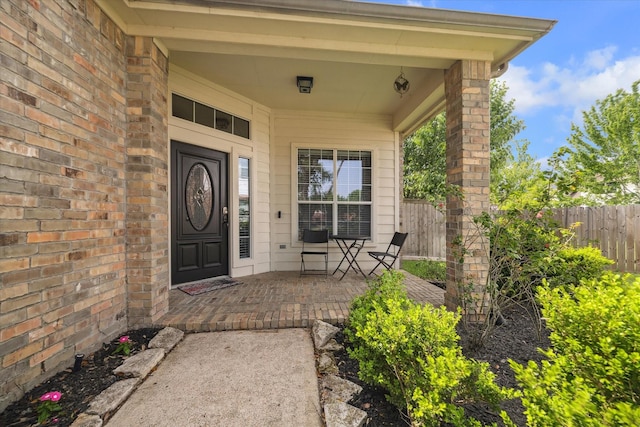 view of exterior entry featuring fence