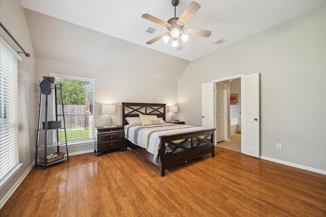 bedroom featuring visible vents, baseboards, wood finished floors, and vaulted ceiling