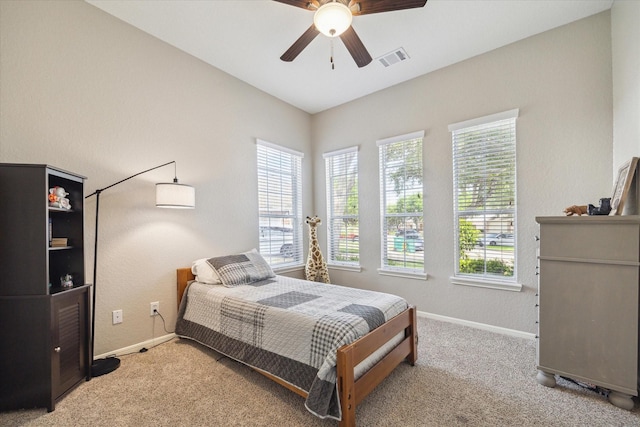bedroom with visible vents, carpet flooring, baseboards, and ceiling fan
