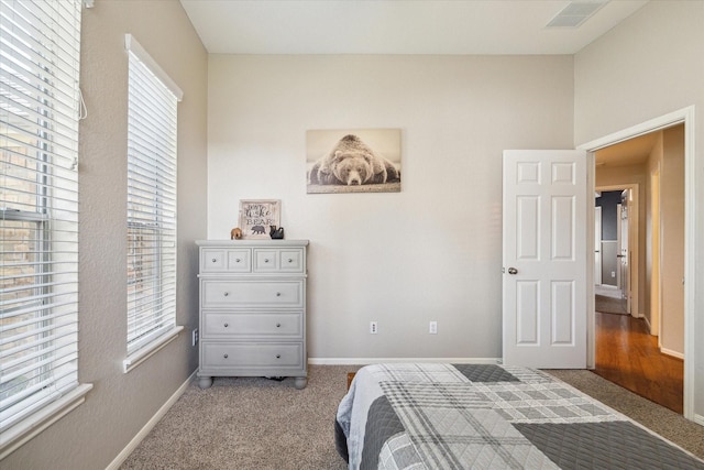 bedroom with visible vents, carpet flooring, and baseboards