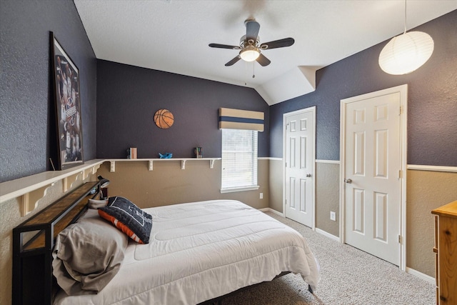 bedroom featuring carpet floors, a ceiling fan, a textured wall, and baseboards