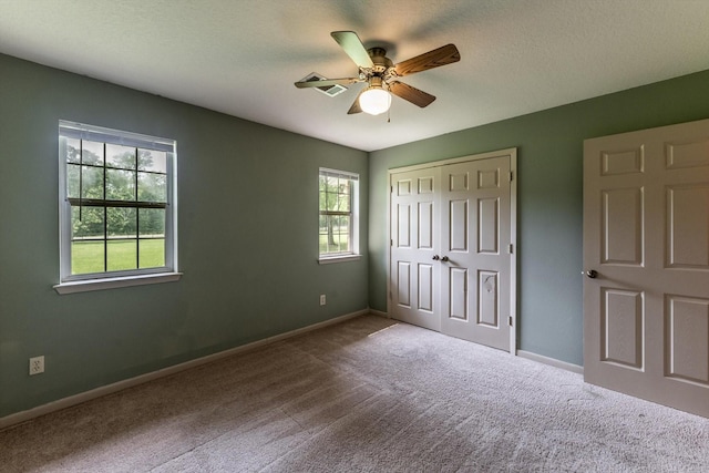 unfurnished bedroom with a closet, carpet flooring, and baseboards