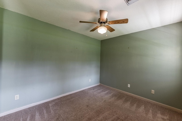 spare room with baseboards, ceiling fan, and carpet flooring