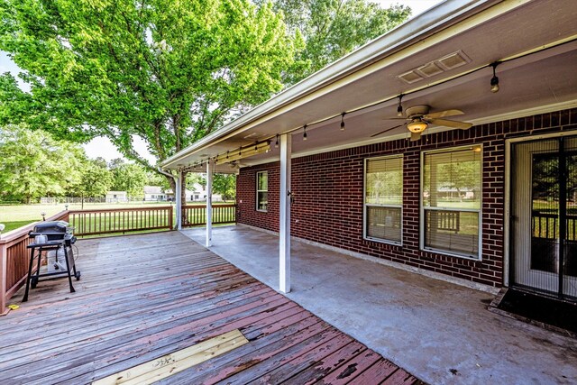 wooden deck featuring a patio, ceiling fan, and visible vents