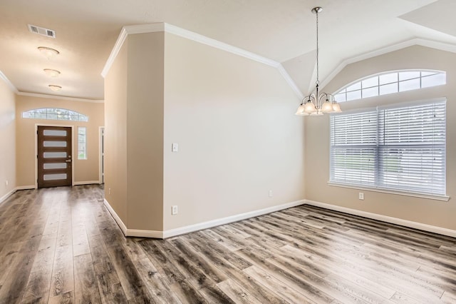 entryway with an inviting chandelier, crown molding, visible vents, wood finished floors, and baseboards