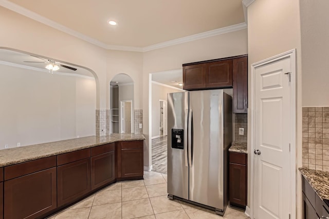 1946 Mayweather Ln, Richmond, TX 77406 - kitchen with stainless steel fridge with ice dispenser, arched walkways, ornamental molding, a ceiling fan, and light stone countertops
