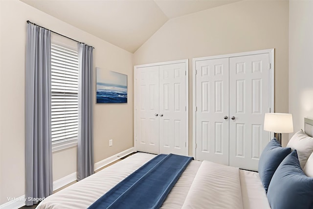1946 Mayweather Ln, Richmond, TX 77406 - bedroom featuring multiple closets, vaulted ceiling, and multiple windows