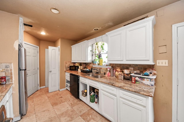 kitchen with white cabinets, a sink, recessed lighting, decorative backsplash, and black appliances