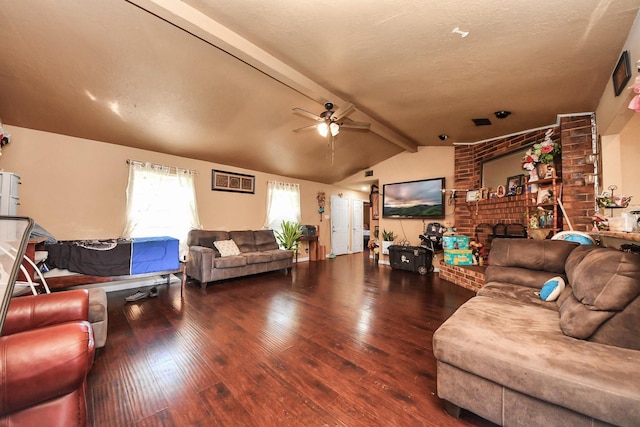 living area with vaulted ceiling with beams, a brick fireplace, ceiling fan, and wood finished floors