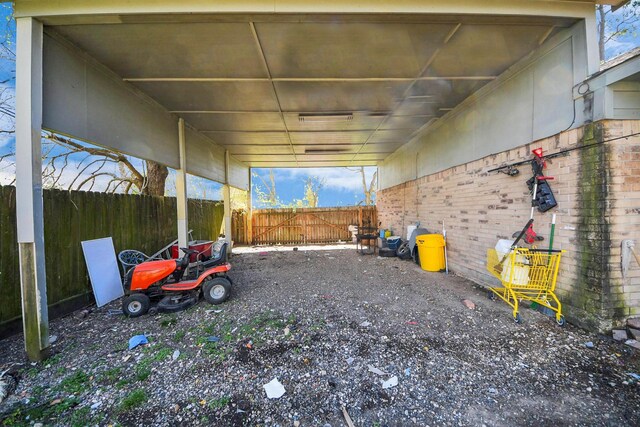 view of yard featuring fence and a carport