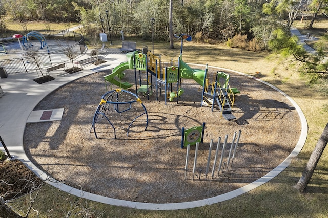 view of community featuring fence and playground community