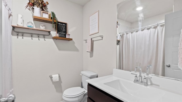 bathroom with toilet, curtained shower, and vanity