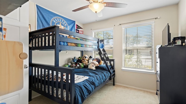 carpeted bedroom with baseboards and ceiling fan