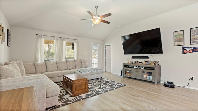 living room featuring baseboards, ceiling fan, wood finished floors, and lofted ceiling