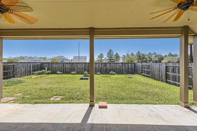 view of yard with ceiling fan, a fenced backyard, and a patio area