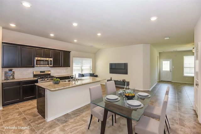 kitchen featuring a sink, decorative backsplash, appliances with stainless steel finishes, and a healthy amount of sunlight