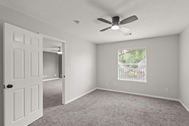 spare room with baseboards, ceiling fan, carpet, and visible vents