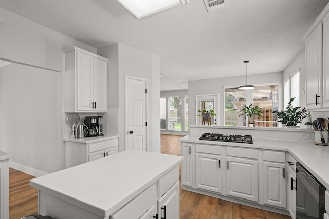 kitchen with visible vents, white cabinetry, gas stovetop, and a wealth of natural light
