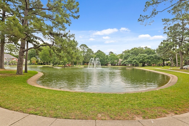 surrounding community featuring a water view and a yard