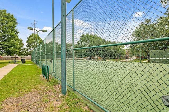view of tennis court featuring fence