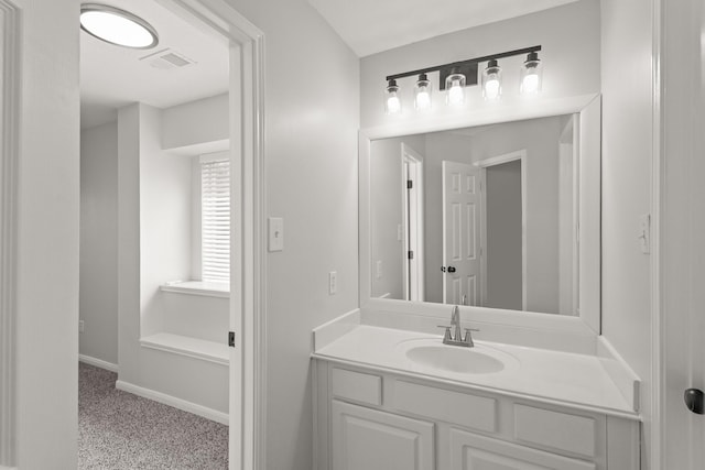 bathroom with baseboards, vanity, and visible vents